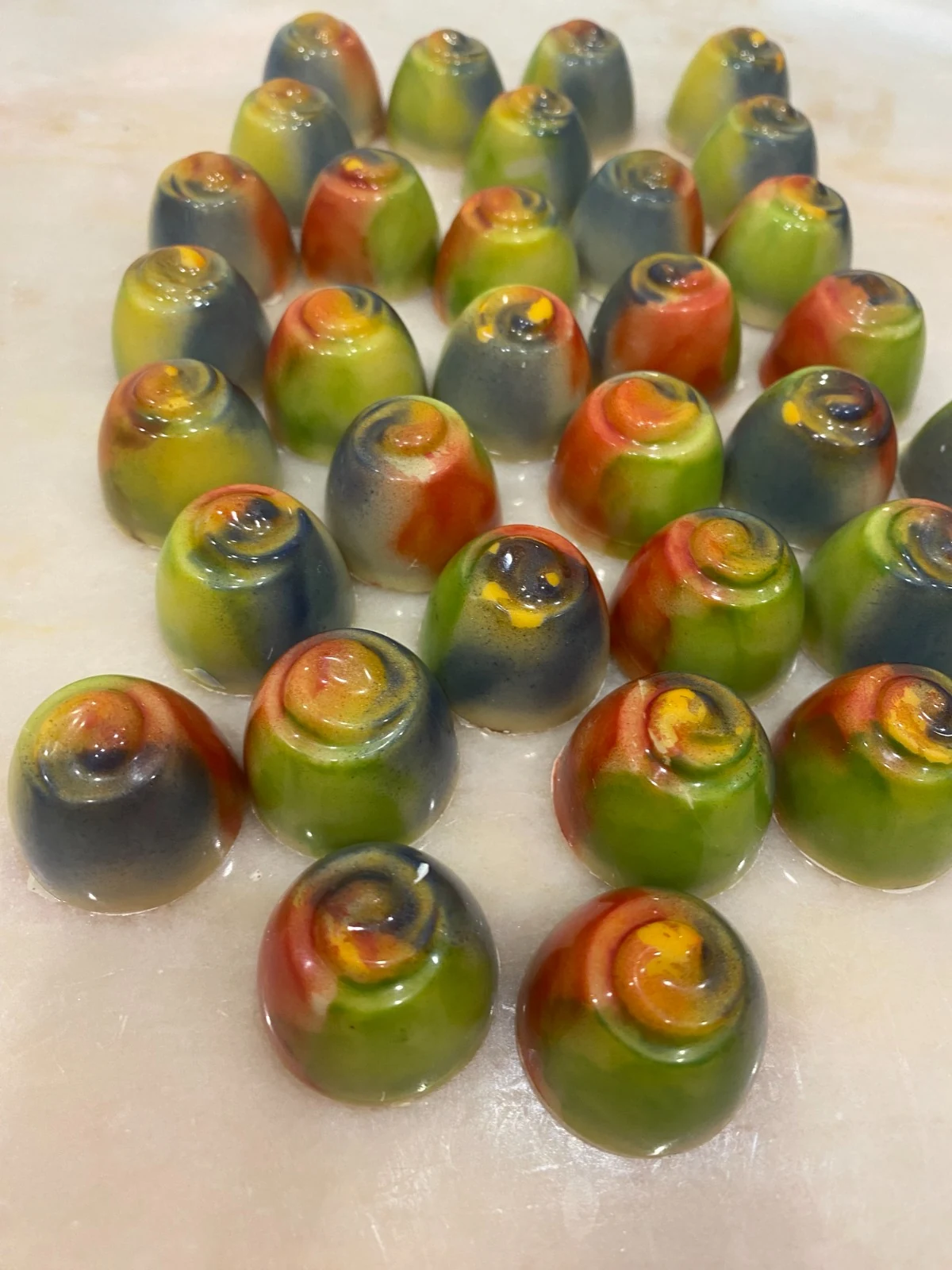 Green and amber artisan pralines